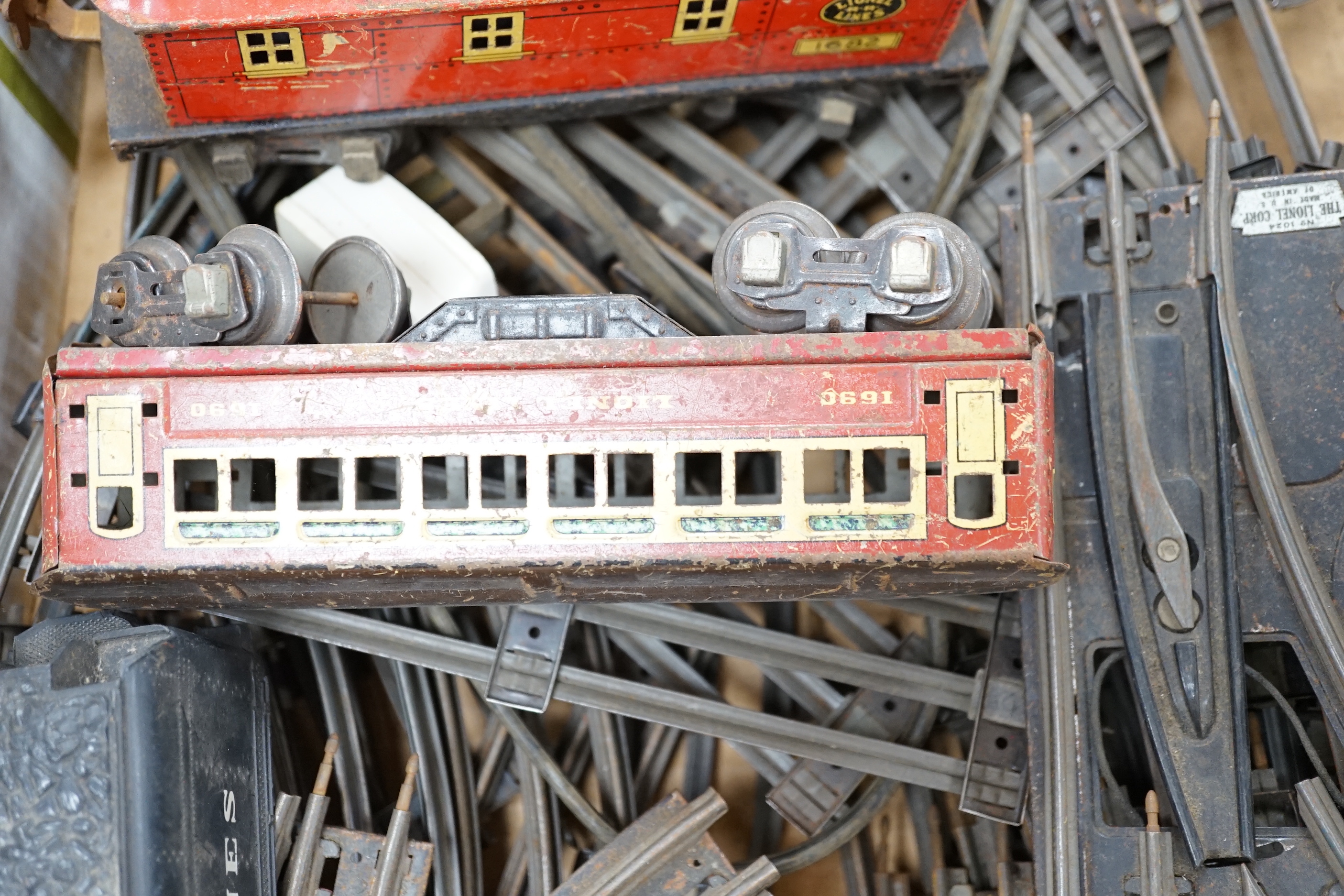 Lionel Lines gauge O tinplate American outline model railway, including seven items of rolling stock together with a quantity of three rail track sections